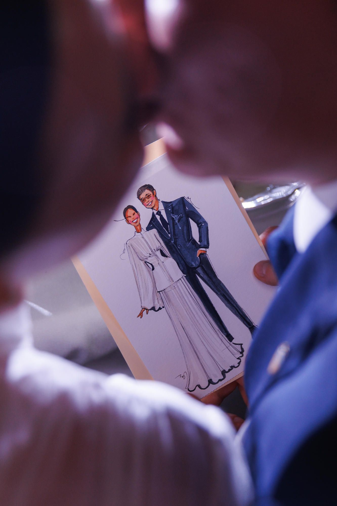A personalized wedding caricature of the couple, a unique entertainment detail at a luxury destination wedding in Spain.