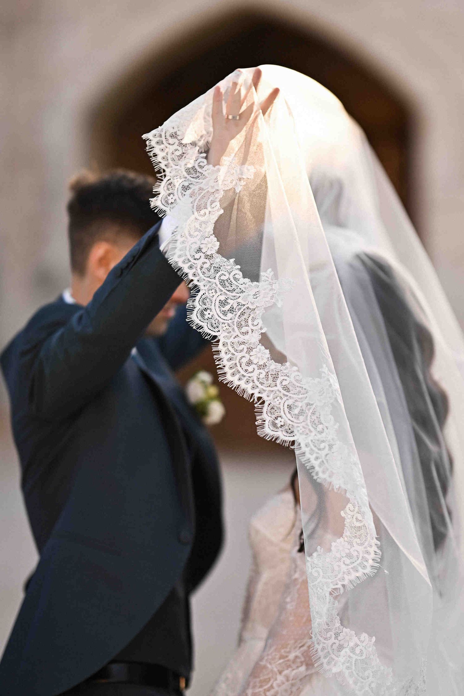 The emotional moment as the groom lifts the bride's veil to see her for the first time