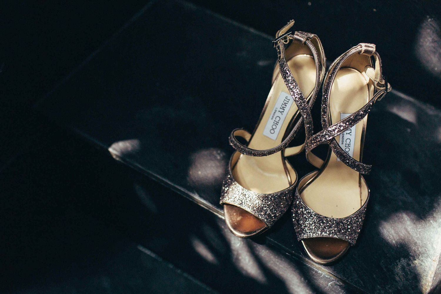 Luxury Jimmy Choo wedding shoes on the stone floor of a historic villa near Barcelona. Editorial detail photography for a destination day