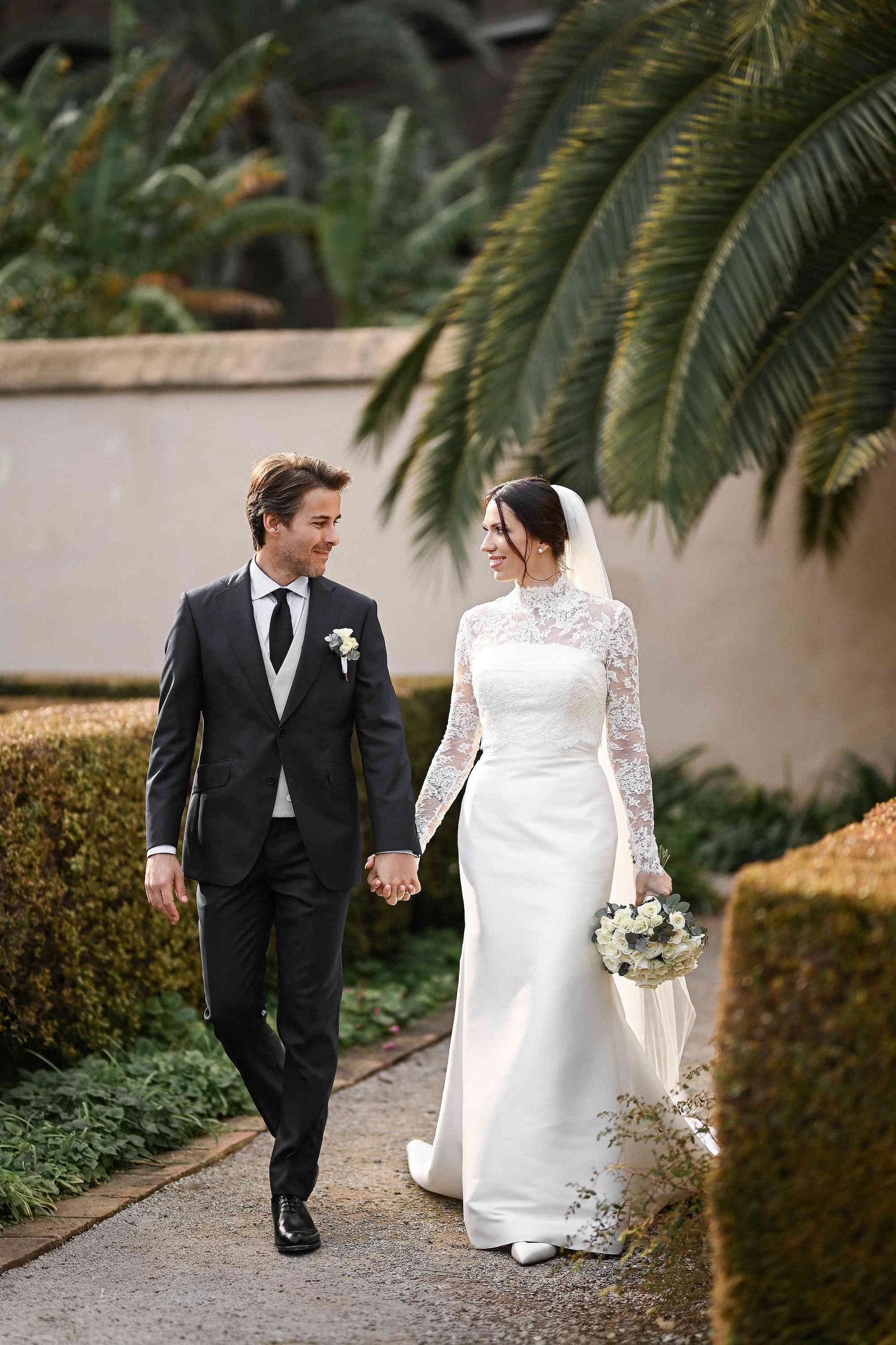 Intimate and emotional embrace of a wedding couple at a luxury private garden in Valencia. Capturing the city’s historic Spanish charm