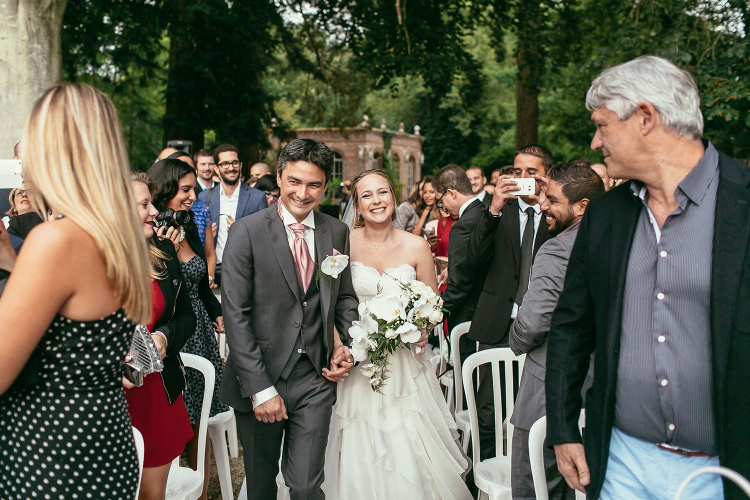 Unscripted emotions at a luxury wedding ceremony. Château de Changy architecture framing a heartfelt, sincere moment