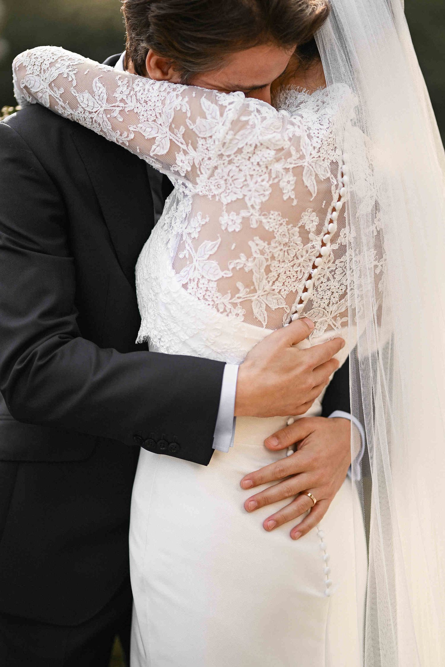 Emotional wedding portrait of a couple's embrace in a picturesque Mediterranean garden. Highlighting the photographer's editorial style