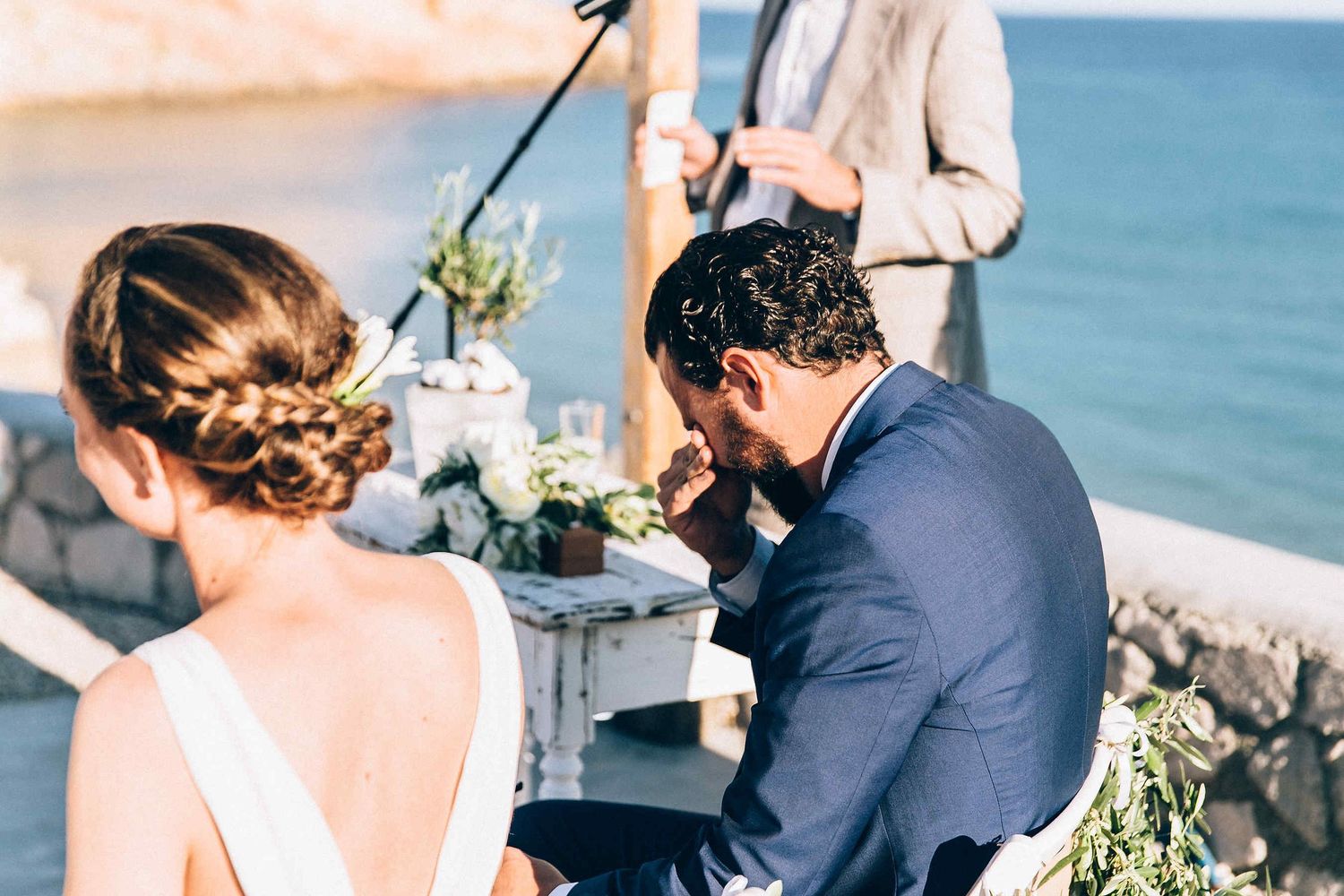 A raw moment of the groom crying while reciting his wedding vows in Milos