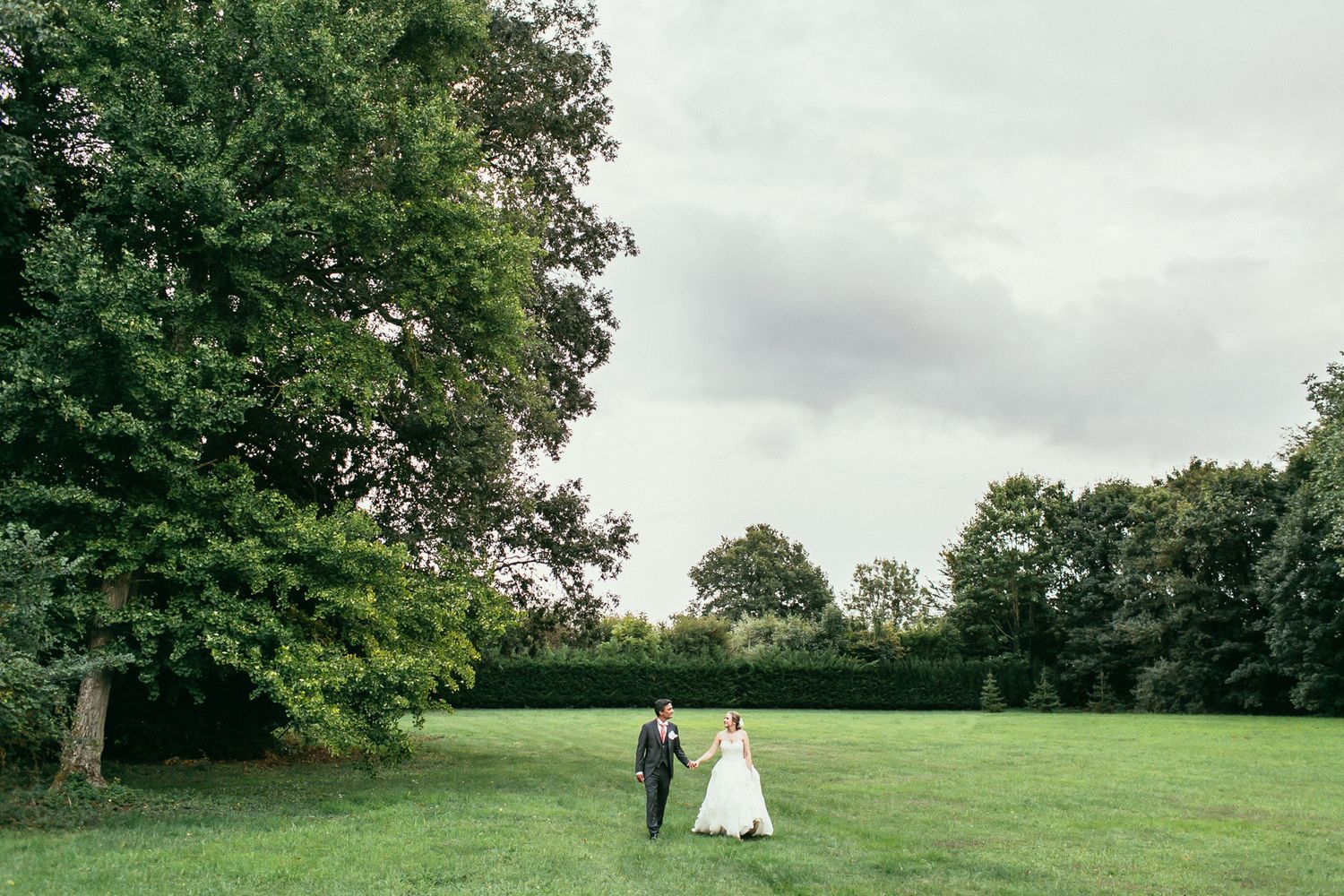 Elegant wedding portrait amidst the manicured hedges of Château de Changy. A blend of nature and French architectural grandeur.