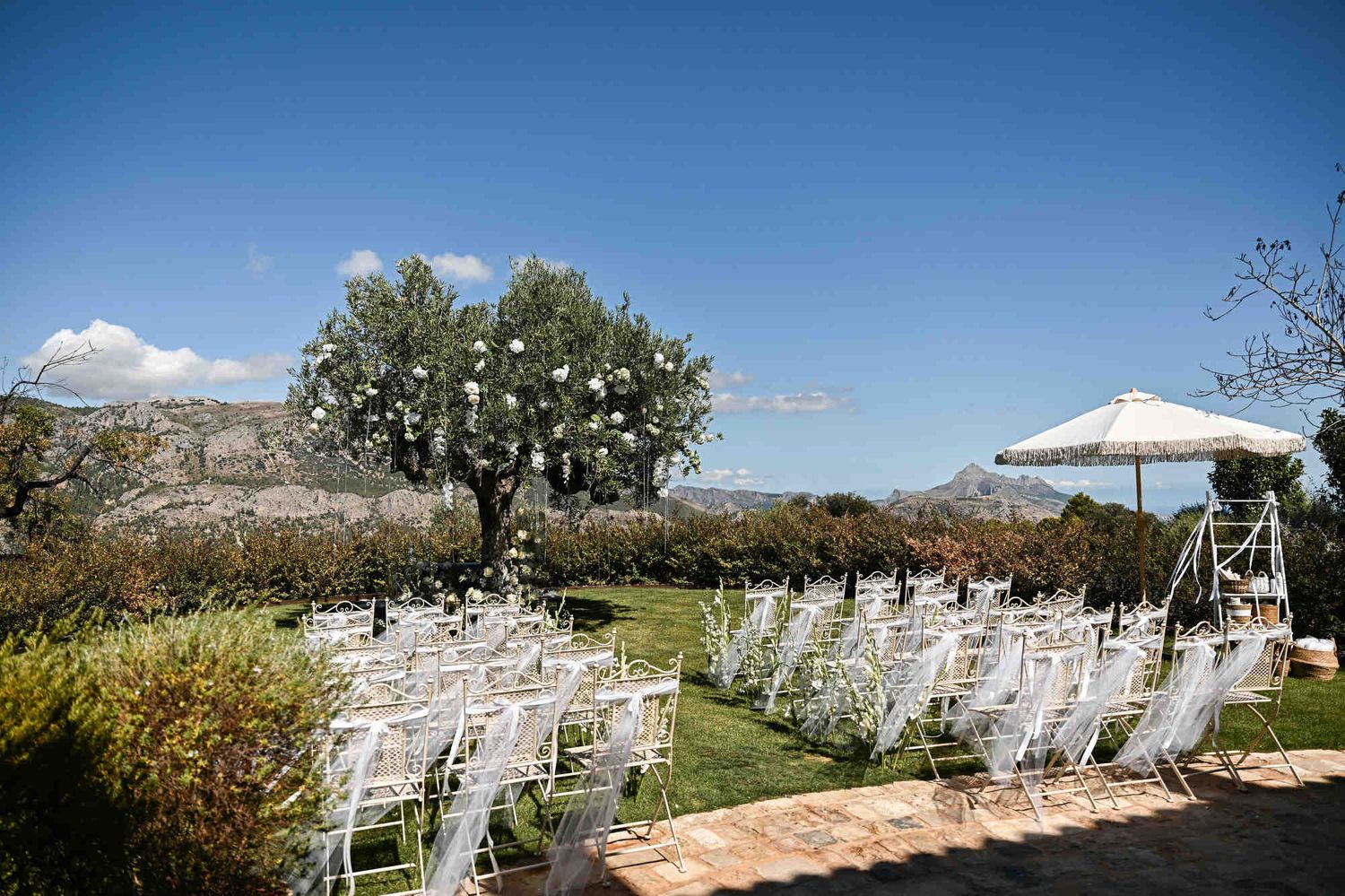 High angle shot of terraced vineyards and mountains surrounding Bodega MASOS wedding venue.