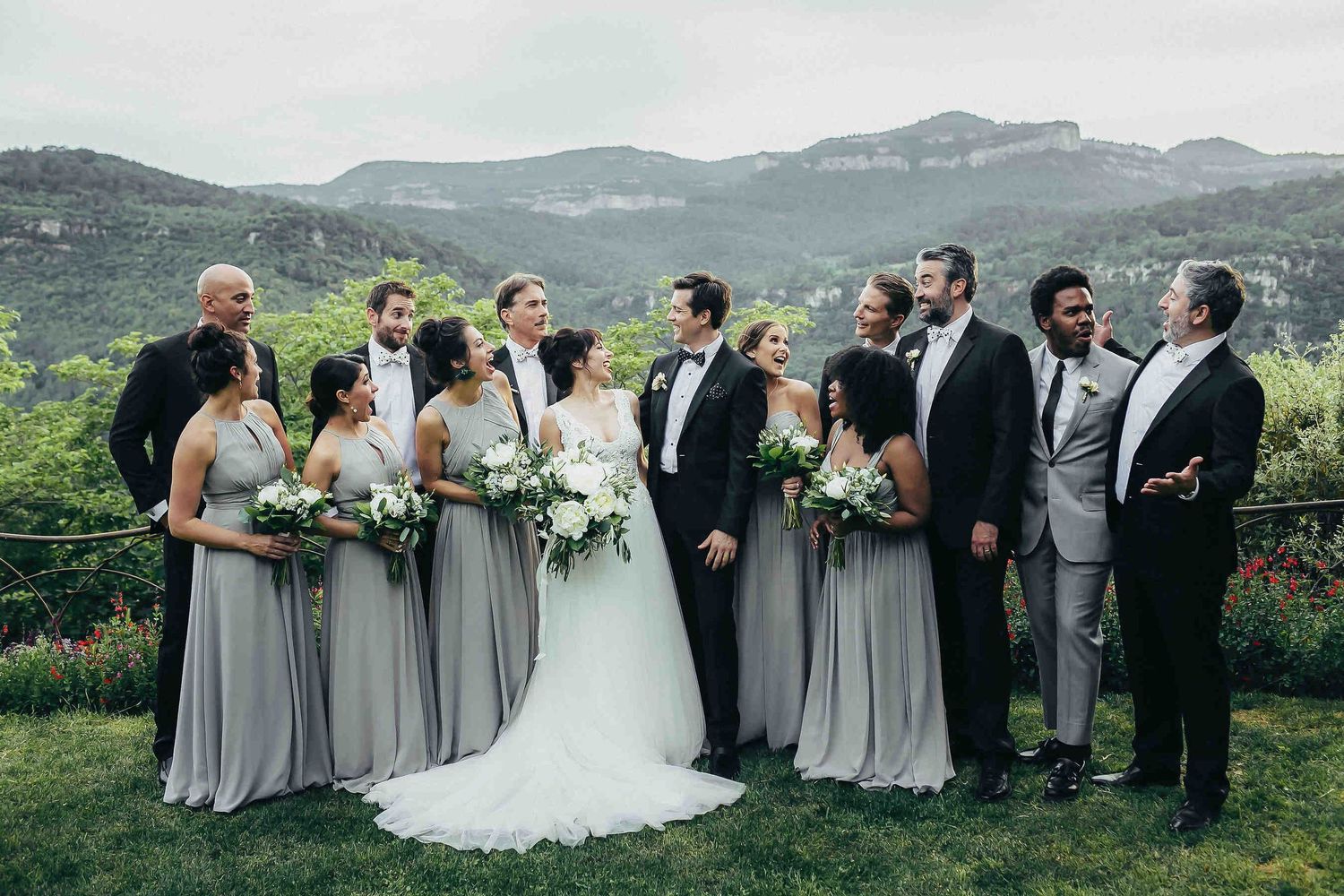 Barcelona wedding photographer. Couple with bridesmaids and groomsmen wearing matching outfits in the scenic mountains of Catalonia
