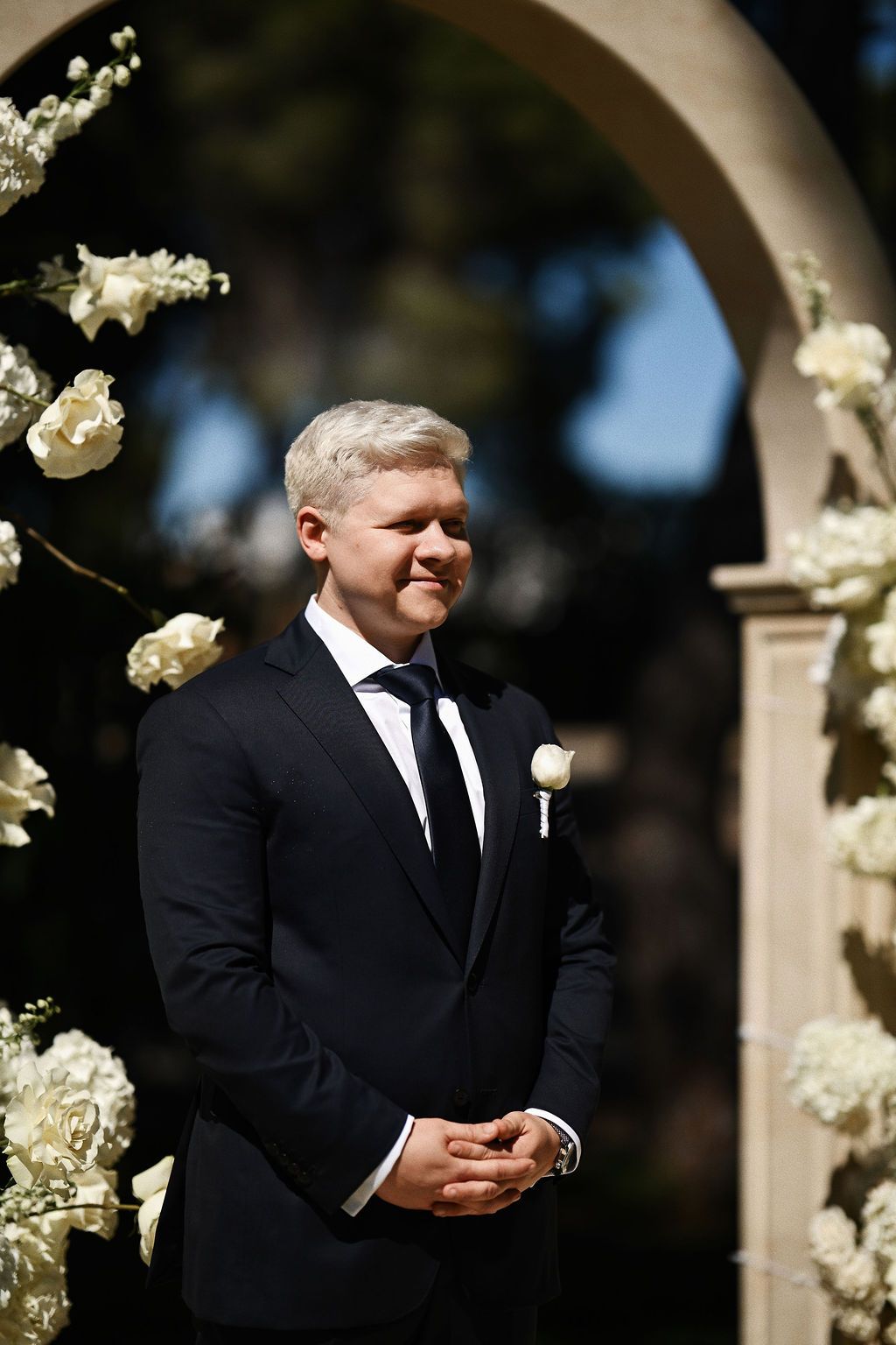 The groom's emotional reaction while watching his bride walk down the aisle at El Bosque ceremony area during a Benidorm wedding.