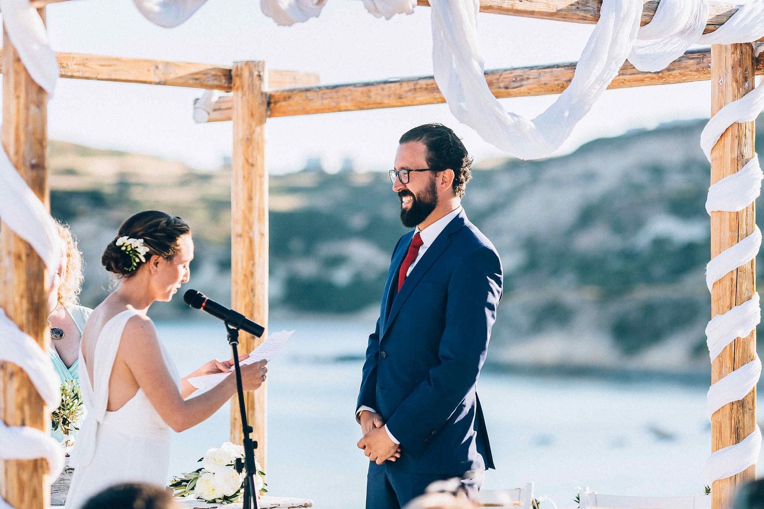 The bride reciting her wedding vows with a beautiful Greek landscape in the background