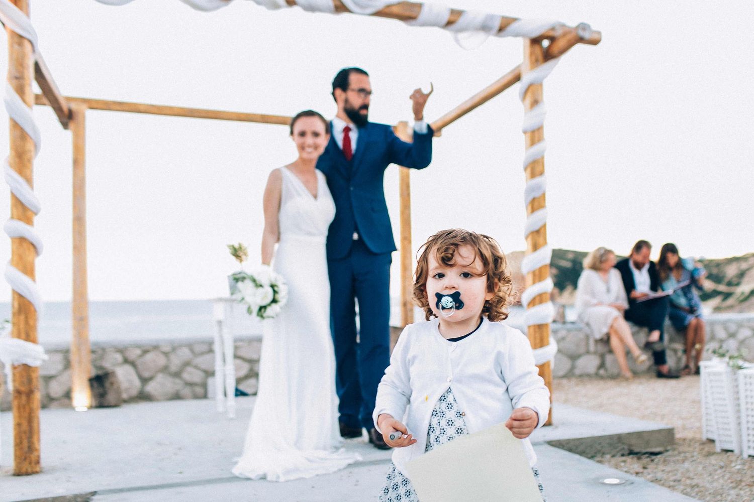 Heartwarming moment of the bride and groom with a small child during the wedding day