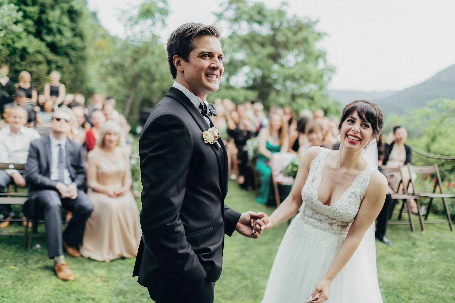 The bride and groom laughing and sharing a joyful moment during their ceremony at a luxury villa in Spain. Vibrant and authentic imagery
