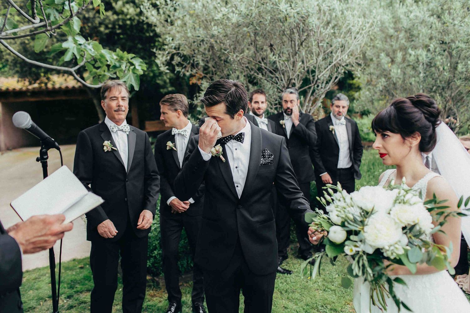 A moving moment of the groom tearing up during the ceremony holding brides hand at private Barcelona villa