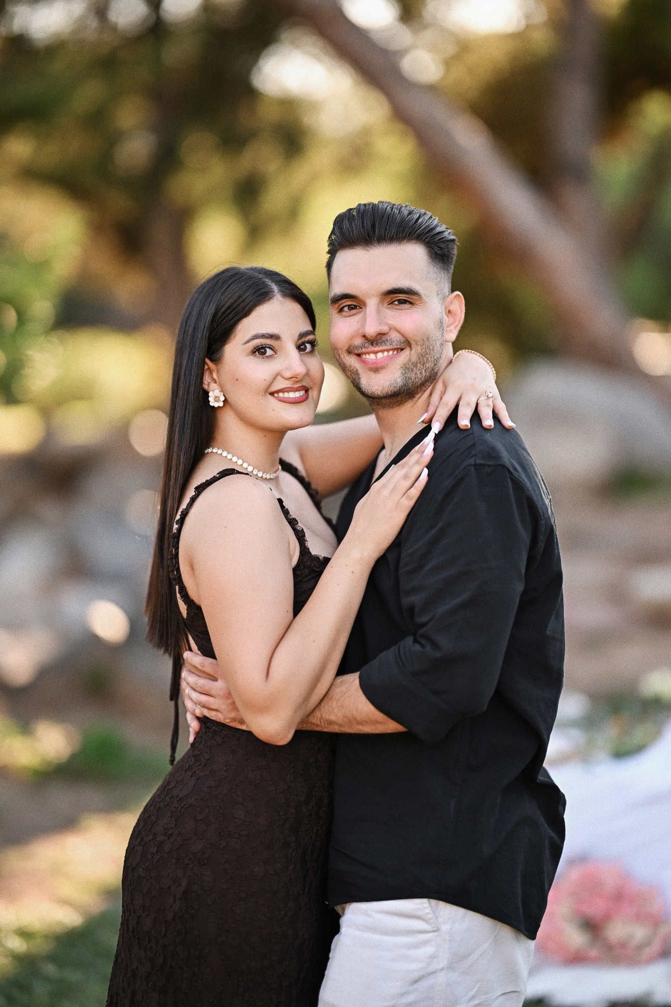 Viveros proposal photographer captures a classic portrait of the newly engaged couple hugging in Jardin del Real.