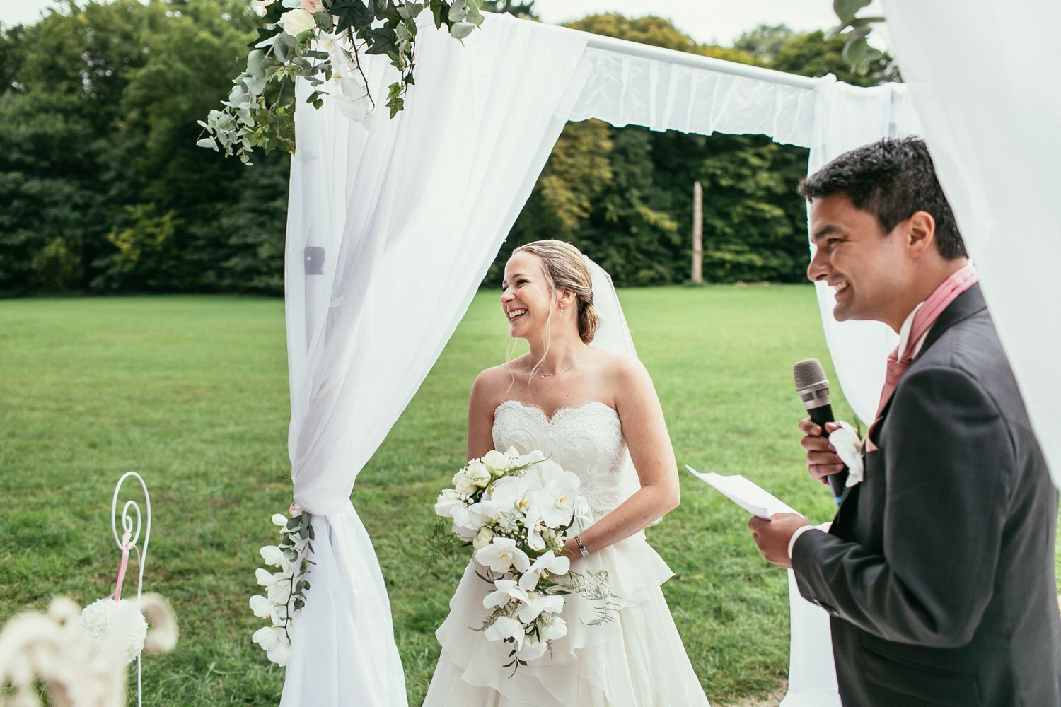 Authentic laughter during the ceremony at Château de Changy. Documentary wedding photography in a French castle