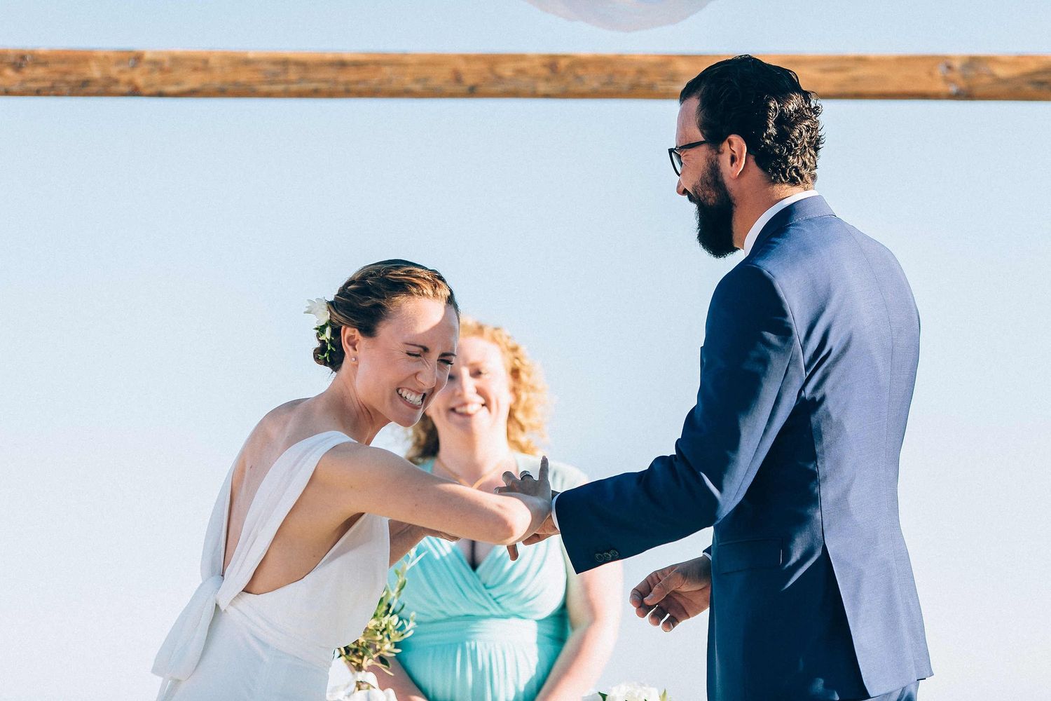 Close-up of the exchange of rings during a destination wedding ceremony in Greece