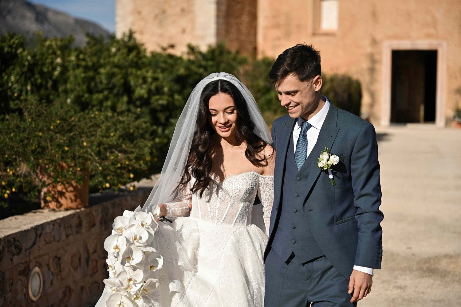 Close-up portrait of a smiling bride and groom during their wedding session at Monasterio de Santa María de la Valldigna in Valencia.