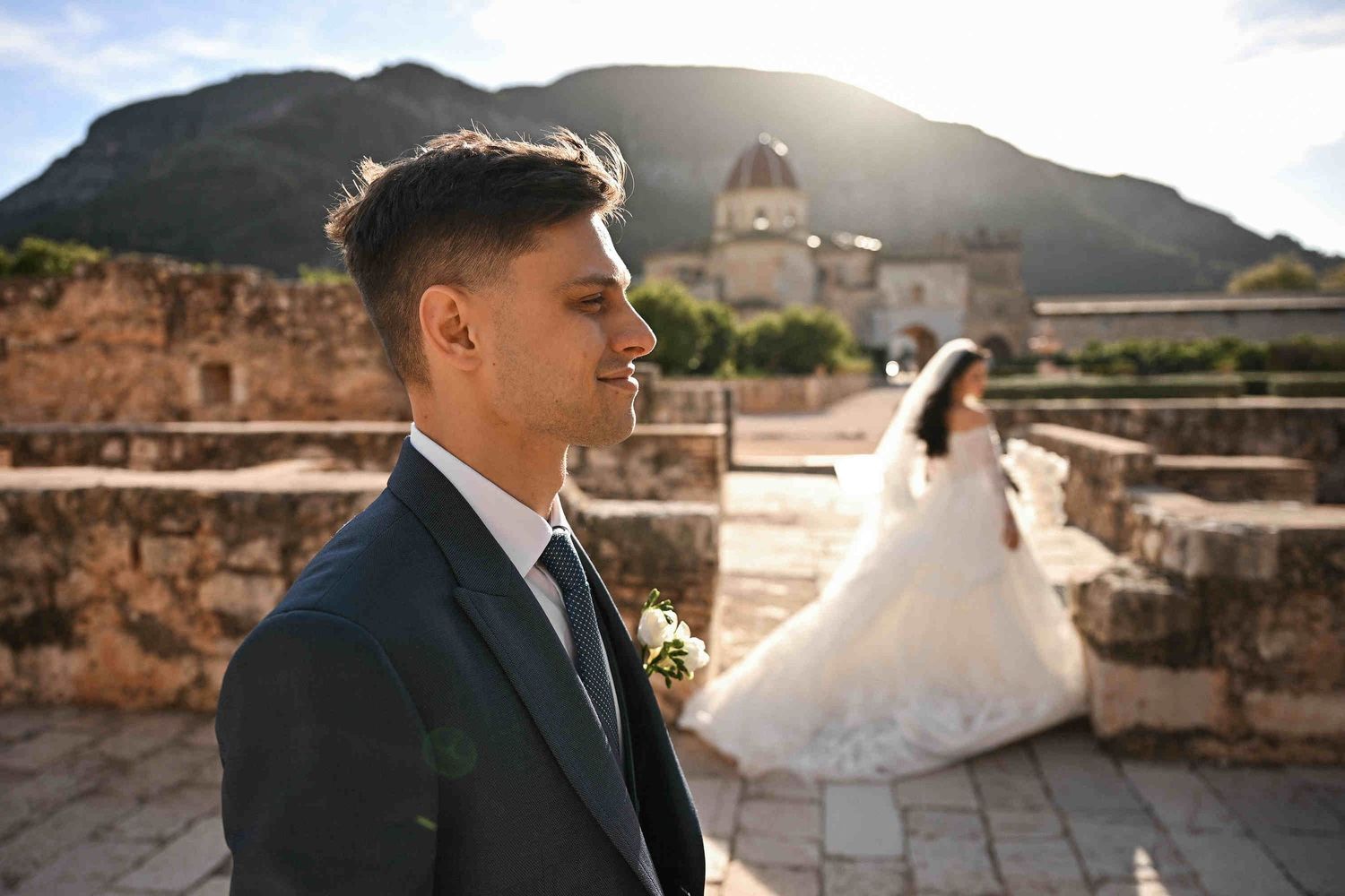 Wedding couple in the golden sunset light at Monasterio de Santa María de la Valldigna, a romantic destination wedding venue in Spain.