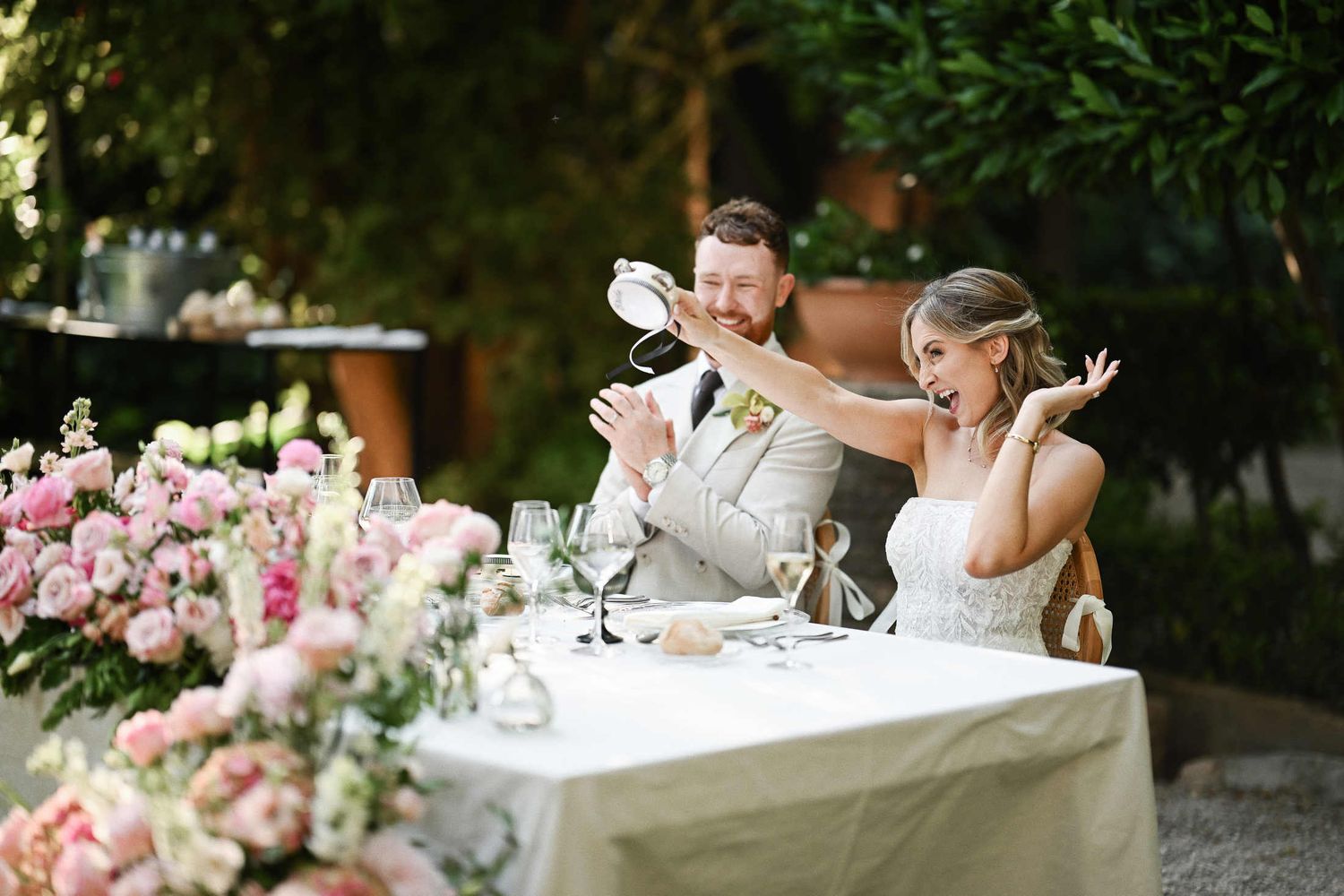 Bride and groom seated at their decorated wedding reception table after the photoshoot and cocktail hour at Villa Dela.