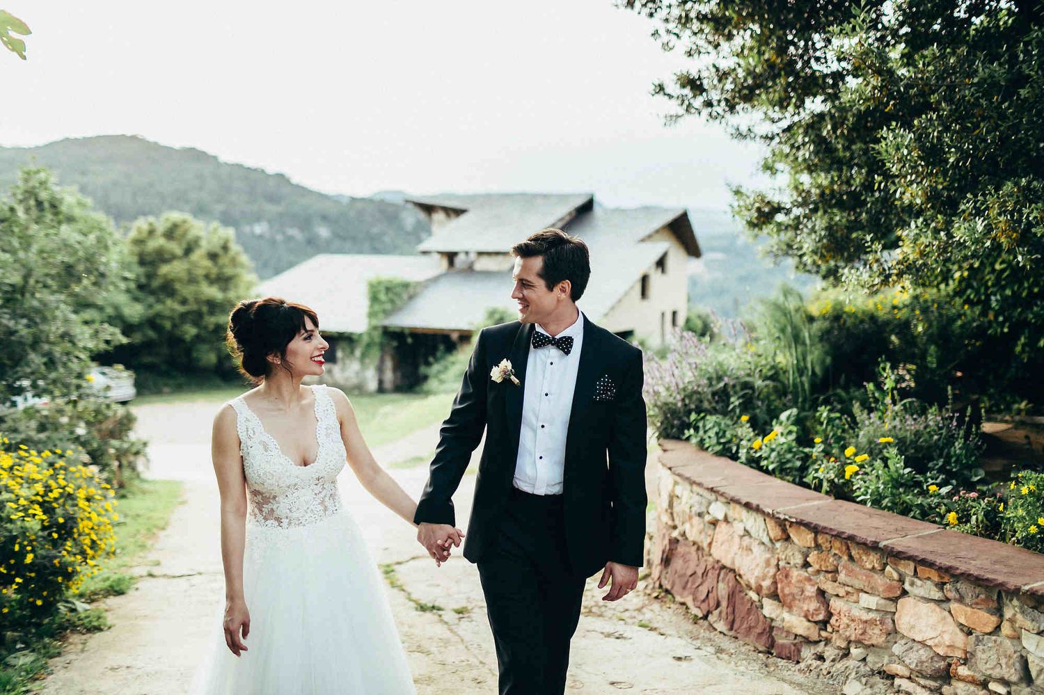 Romantic couple strolling with a loving gaze in front of a luxury European villa. Professional European travel photography.