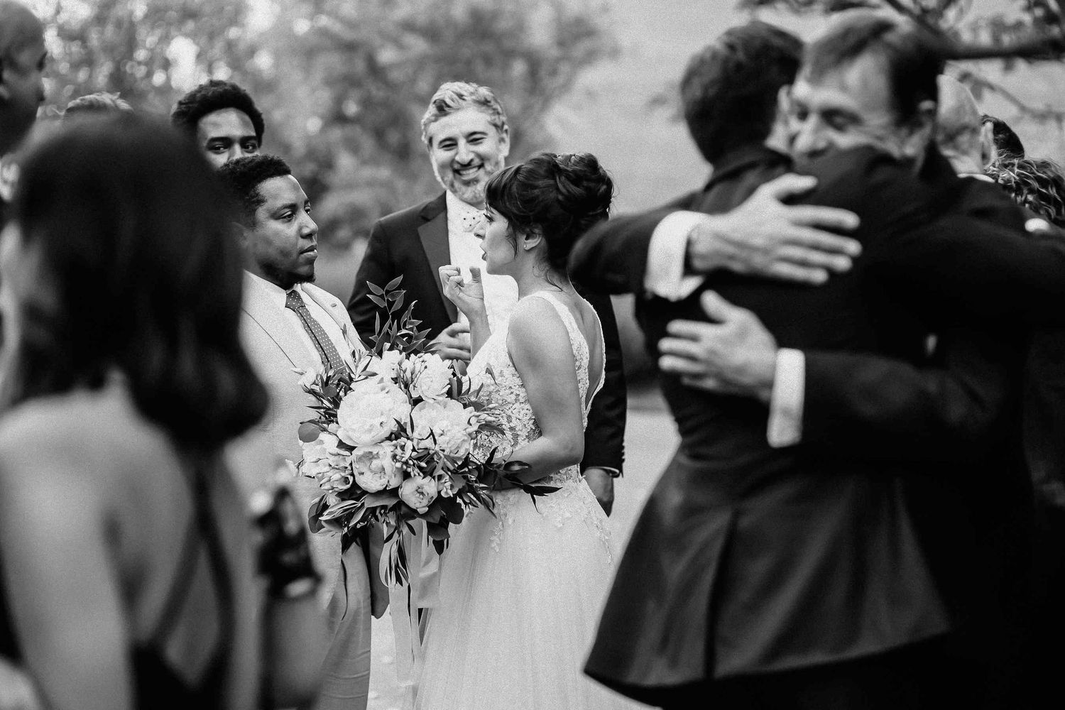 Candid black and white shot of the bride talking with wedding guests at private estate near Barcelona. Natural wedding storytelling-Darista