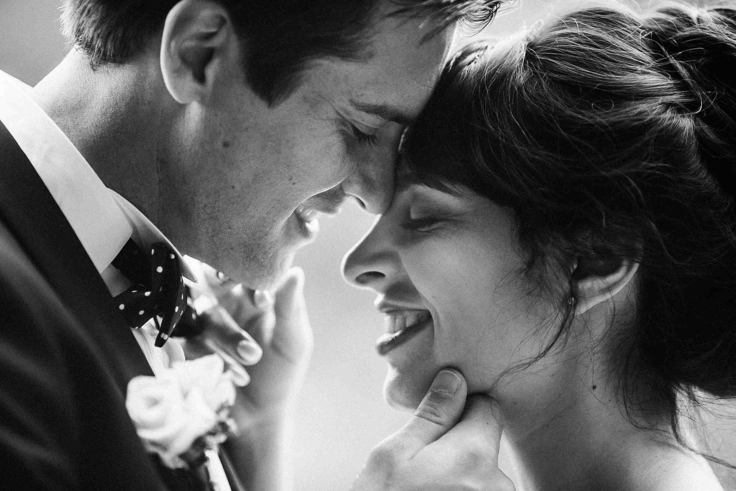 A close-up black and white wedding portrait capturing a tender, sincere moment. Documentary storytelling by wedding photographers in Barcelo