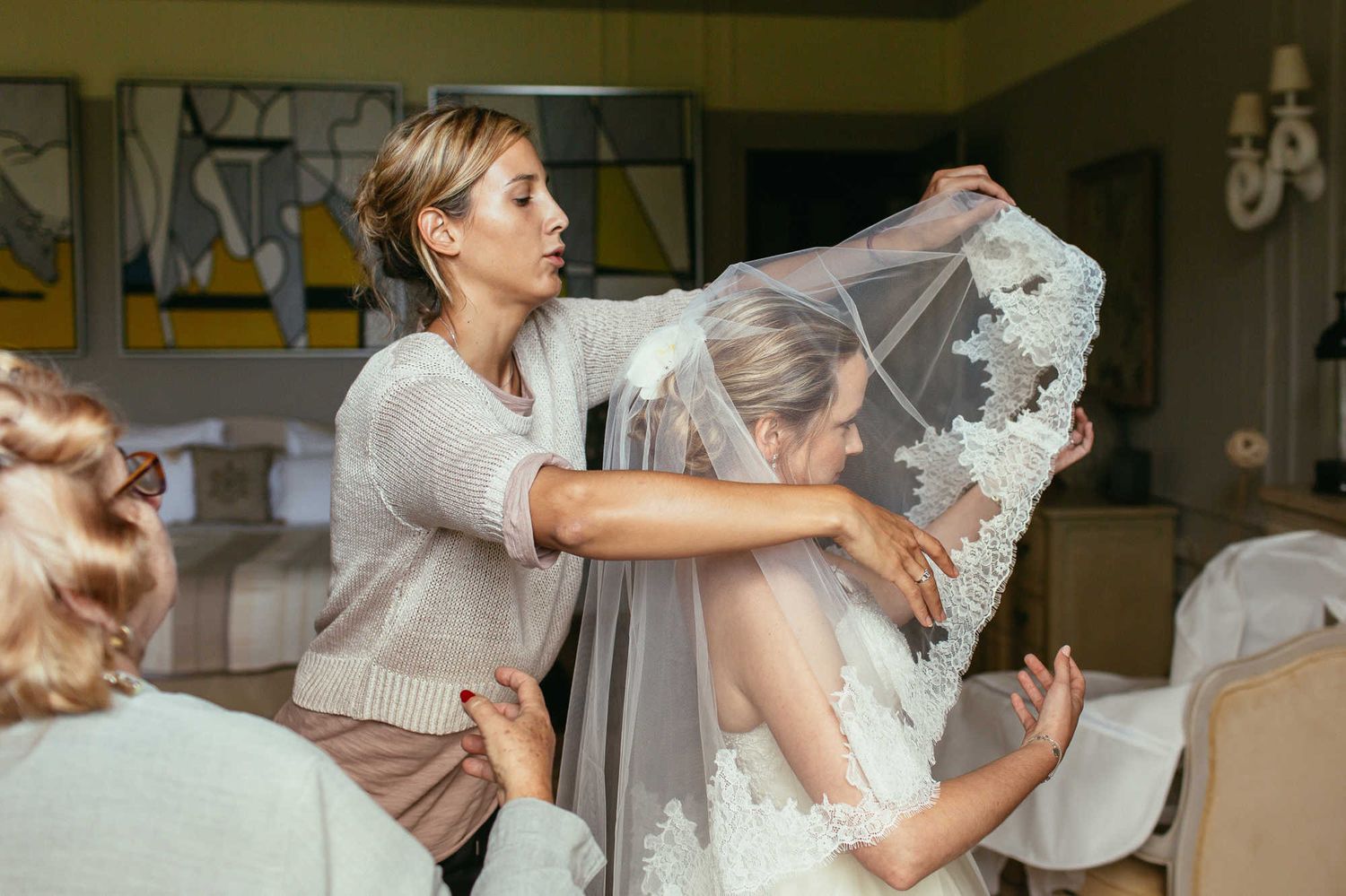 Bridal morning preparations and putting on a veil in a historic Paris chateau before a luxury wedding ceremony in France.