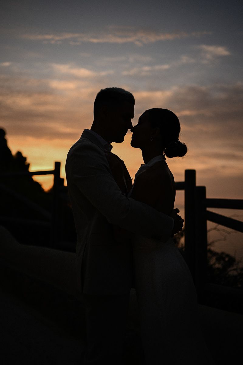 Silhouette of a bride and groom embracing at sunset, shot by a Costa Blanca wedding photographer.