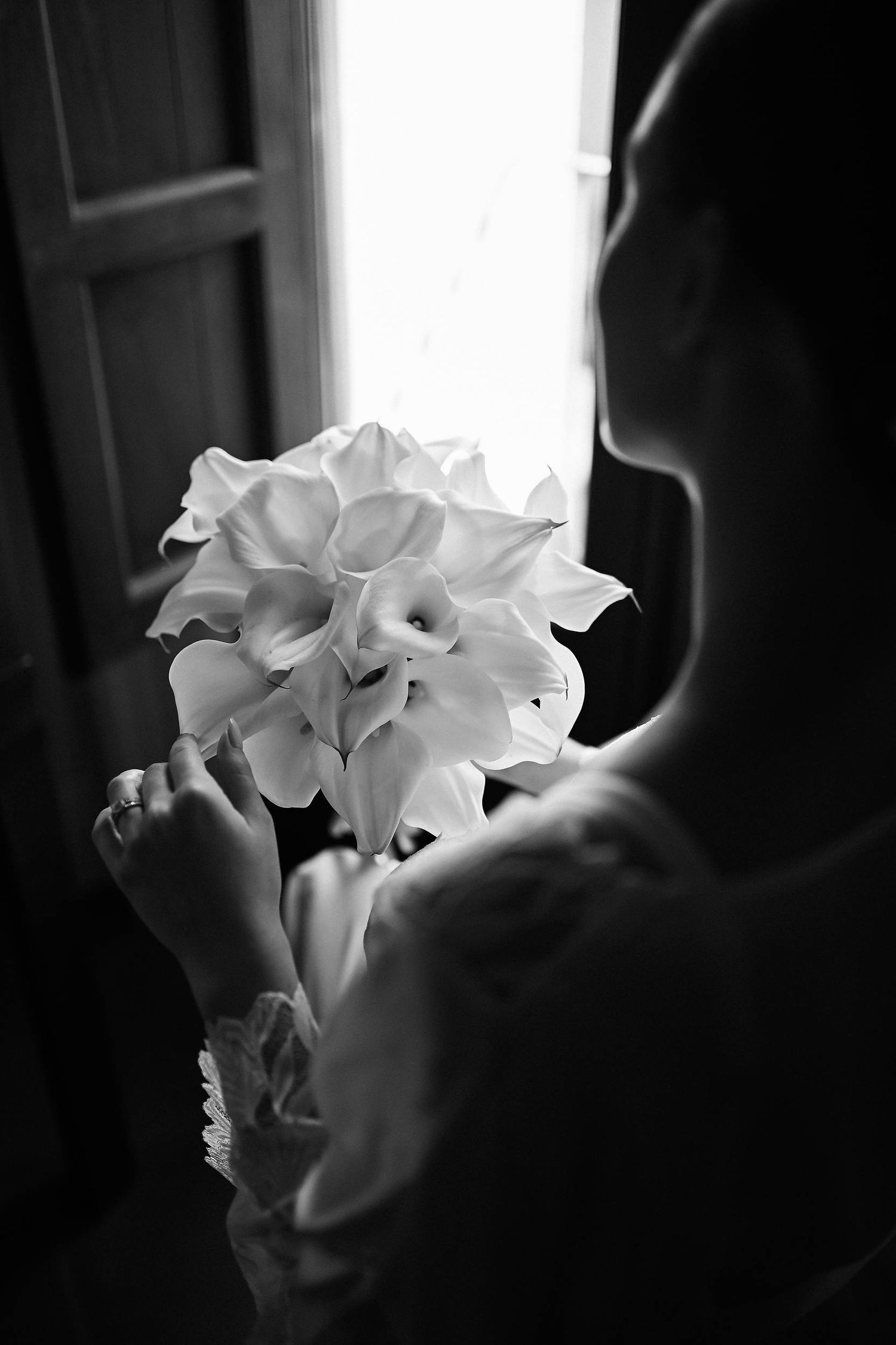 Artistic shot of an engagement ring resting on fresh Calla Lilies, showcasing the 