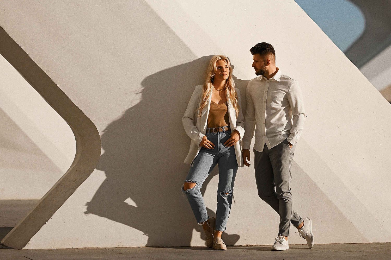 Cinematic engagement photos of a young couple are standing at the City of Arts and Sciences