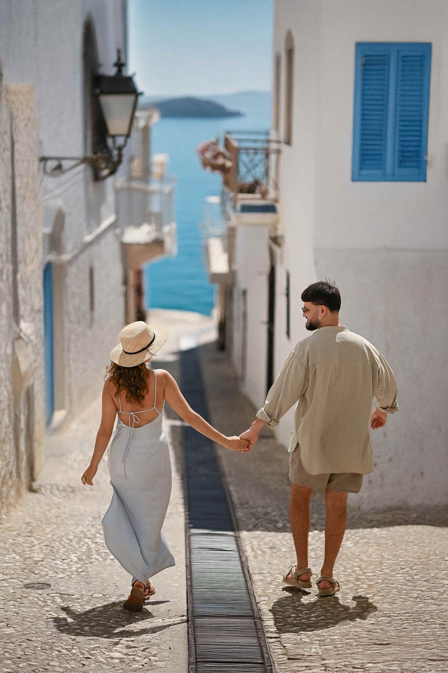 A relaxed couple walking through Altea's old town with a breathtaking view of the Mediterranean Sea near Alicante