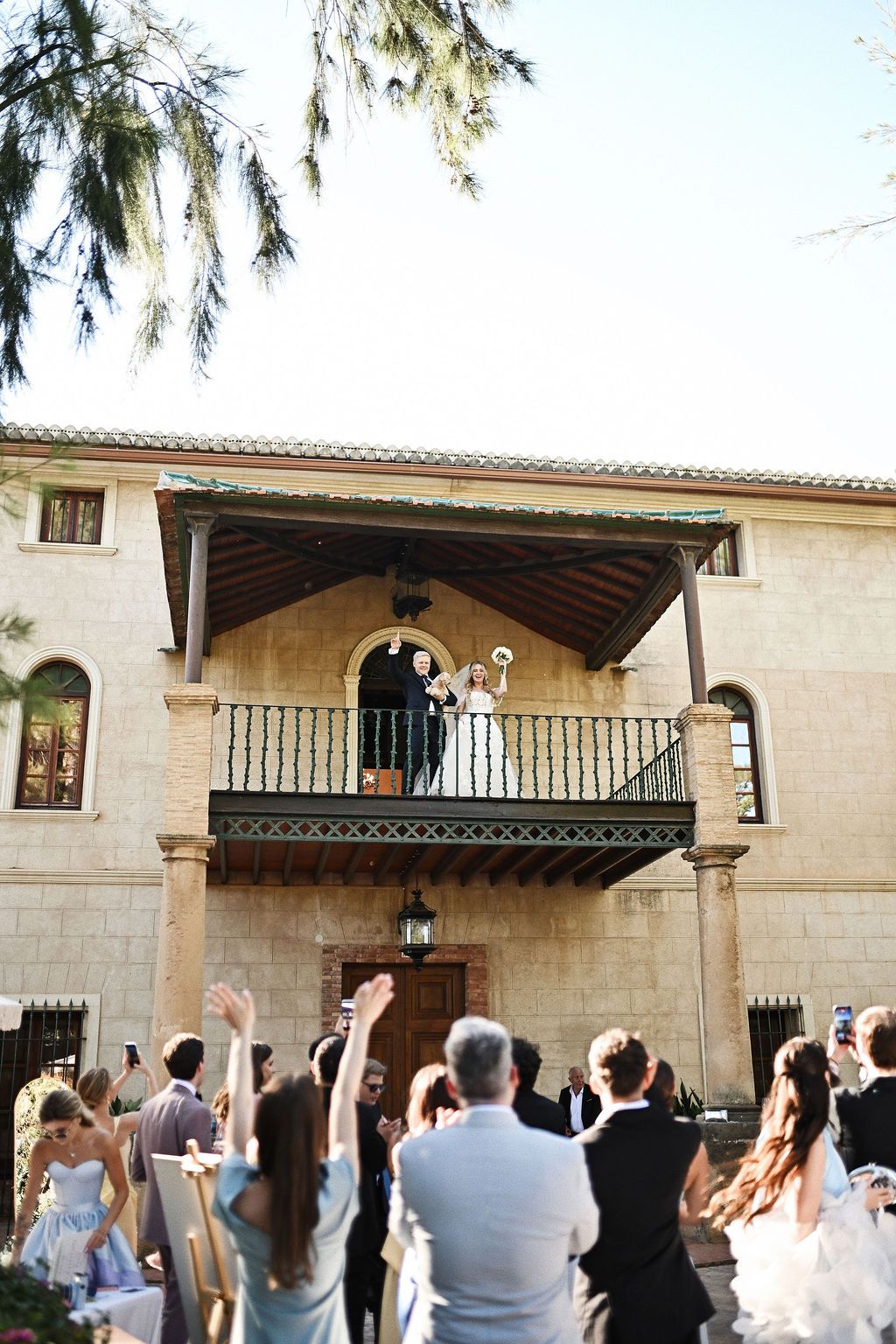 Elegant couple on the villa balcony at Finca El Senyoret. High-fashion destination wedding inspiration in Benidorm, Spain.