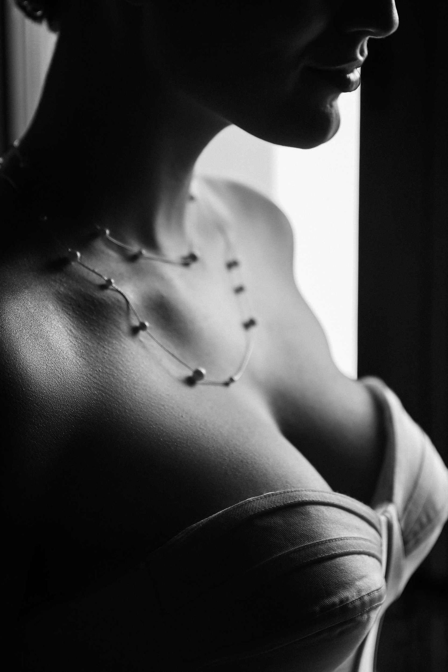 Close-up of the bride's elegant necklace during morning preparations, showcasing 