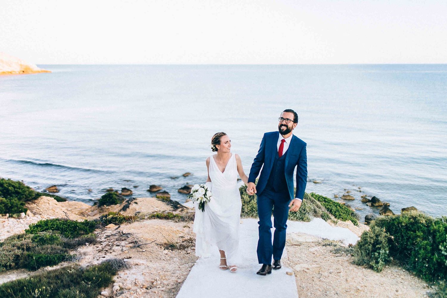 The newlyweds walking back to the guests from their private photo session to join the celebration