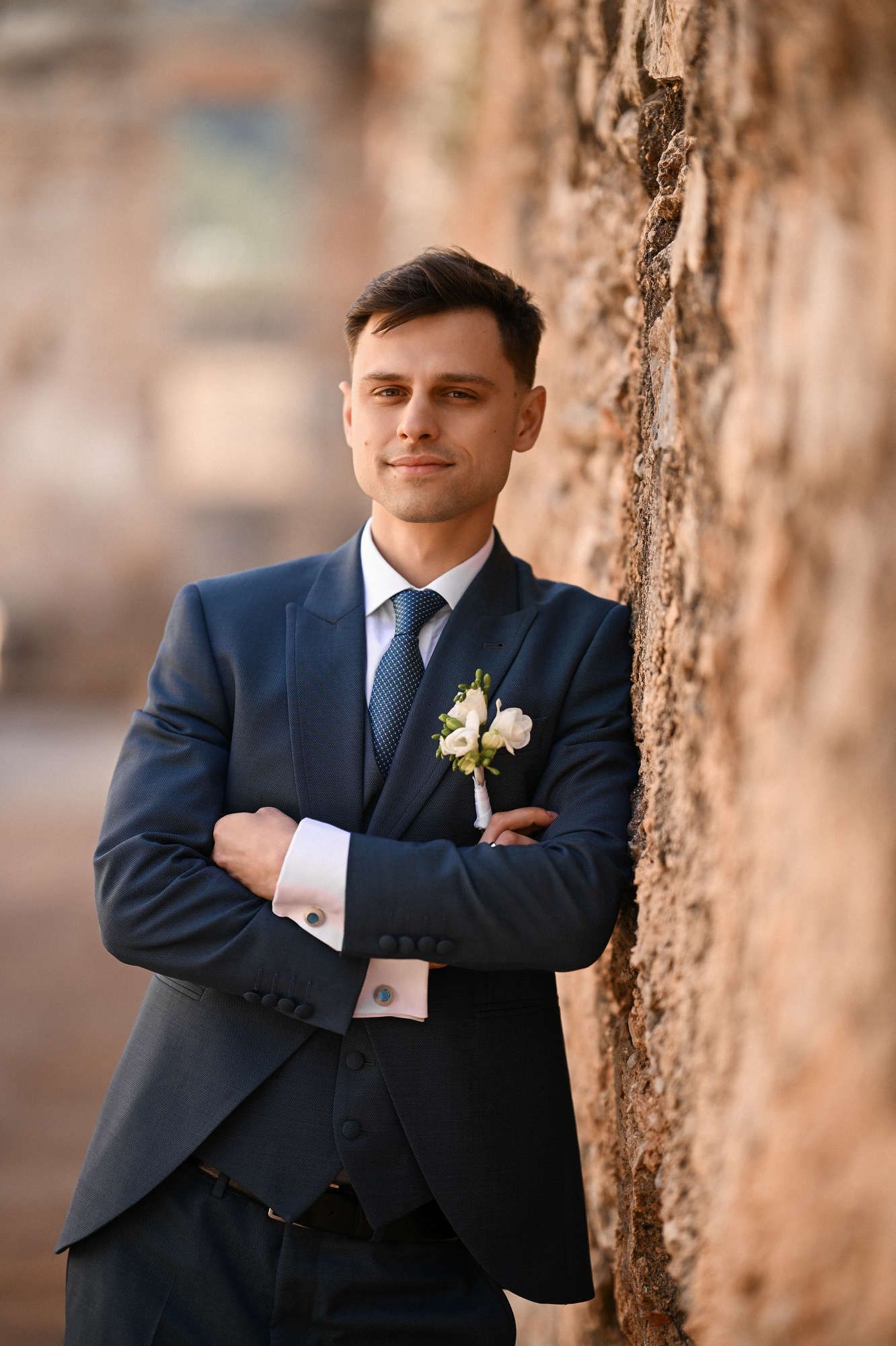 Close-up portrait of the groom in the historic courtyard of Monasterio de Santa María de la Valldigna, a premier Spanish wedding venue.
