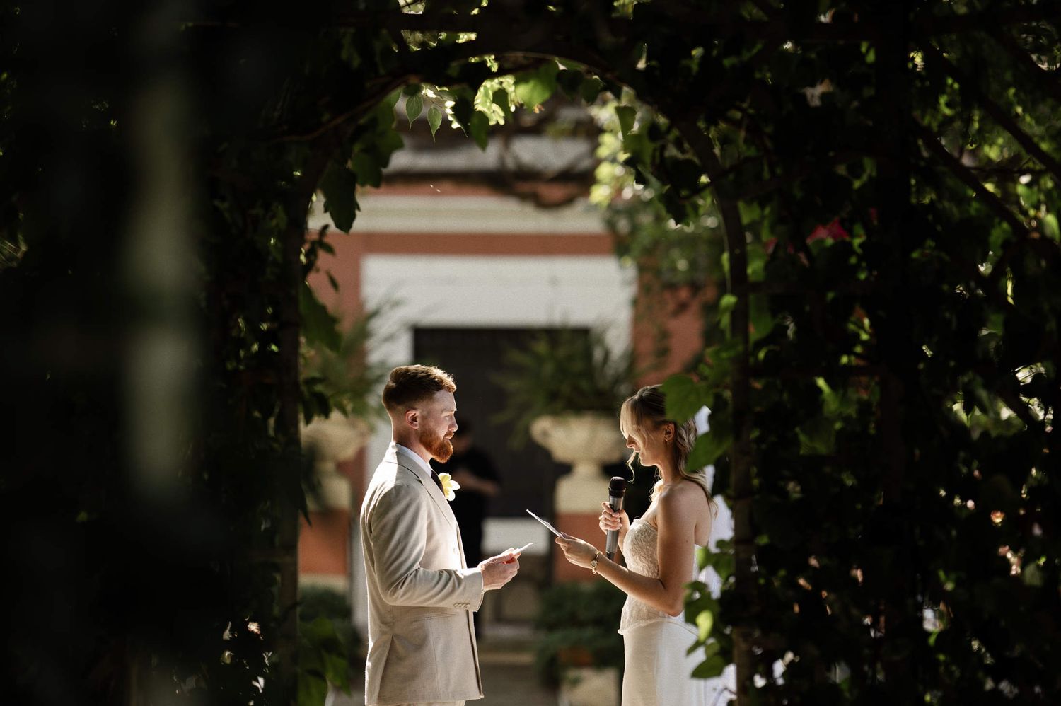 Bride and groom exchanging emotional wedding vows during an outdoor marriage ceremony at Villa Dela venue in Valencia.