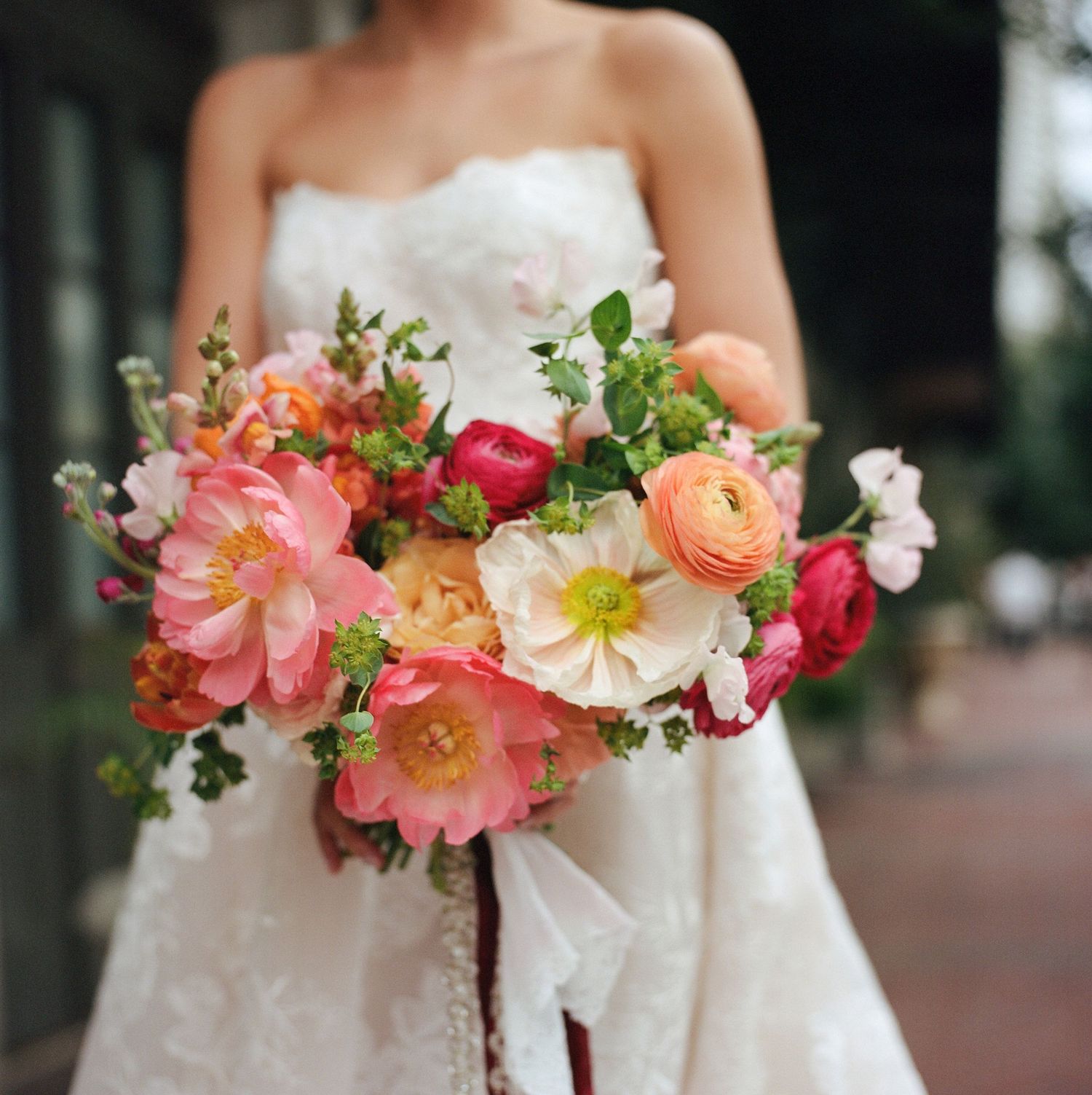 Close-up of a bridal bouquet featuring pink, coral and white flowers.