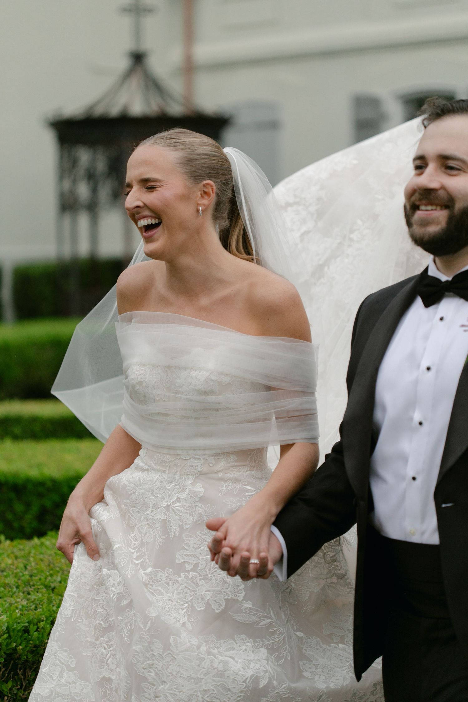 Candid moment of newlyweds laughing together on their wedding day.