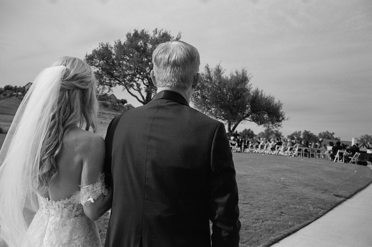 Wedding couple embraces in a series of black and white outdoor portraits.