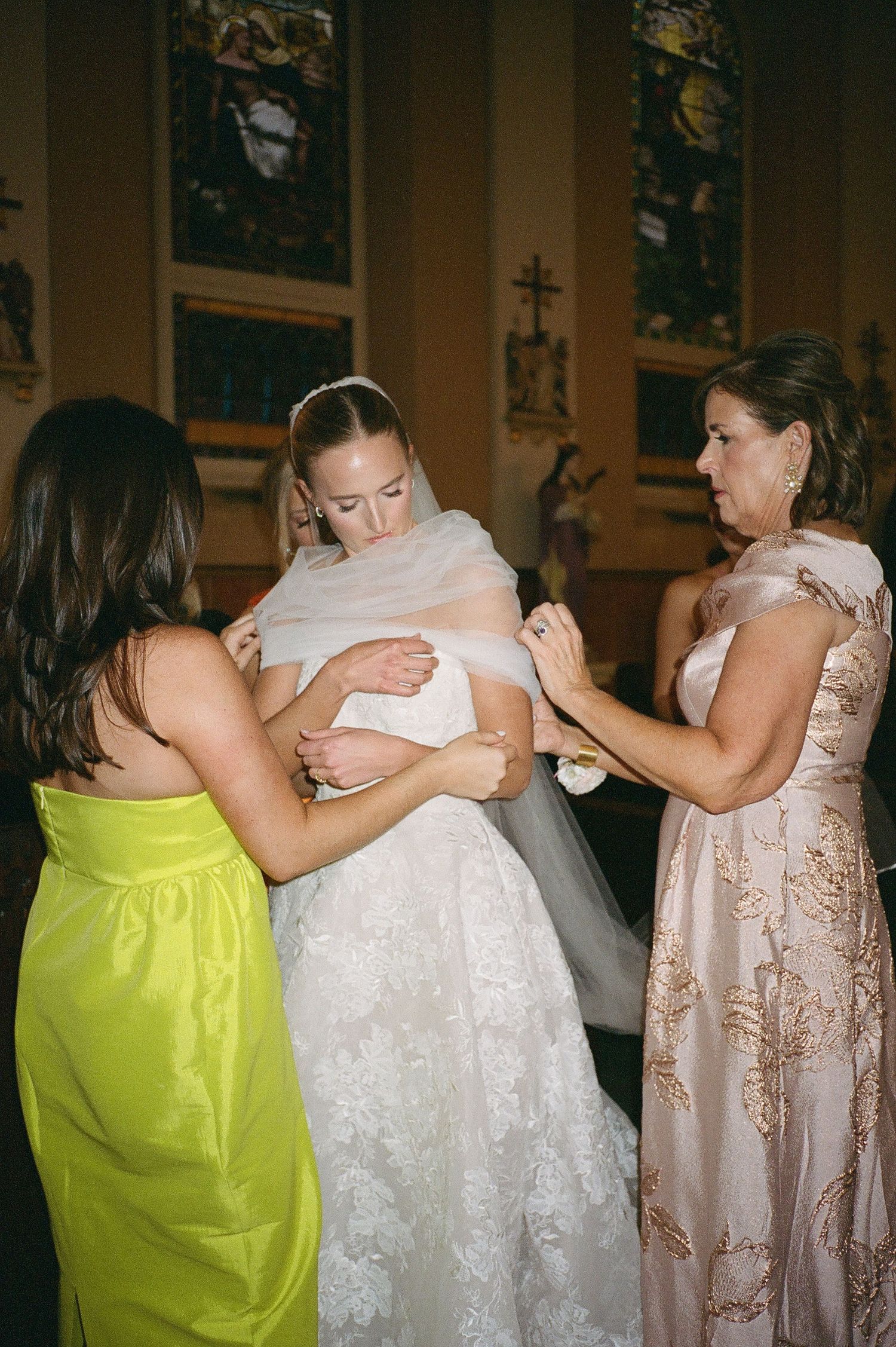 Wedding guests embrace and celebrate on the dance floor during the reception.