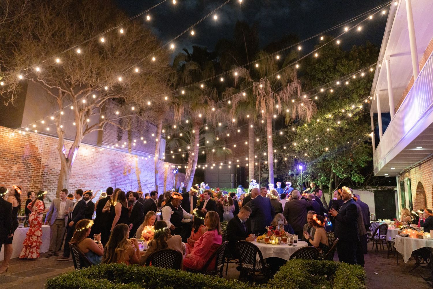 Outdoor wedding reception venue illuminated with string lights creating a magical atmosphere.