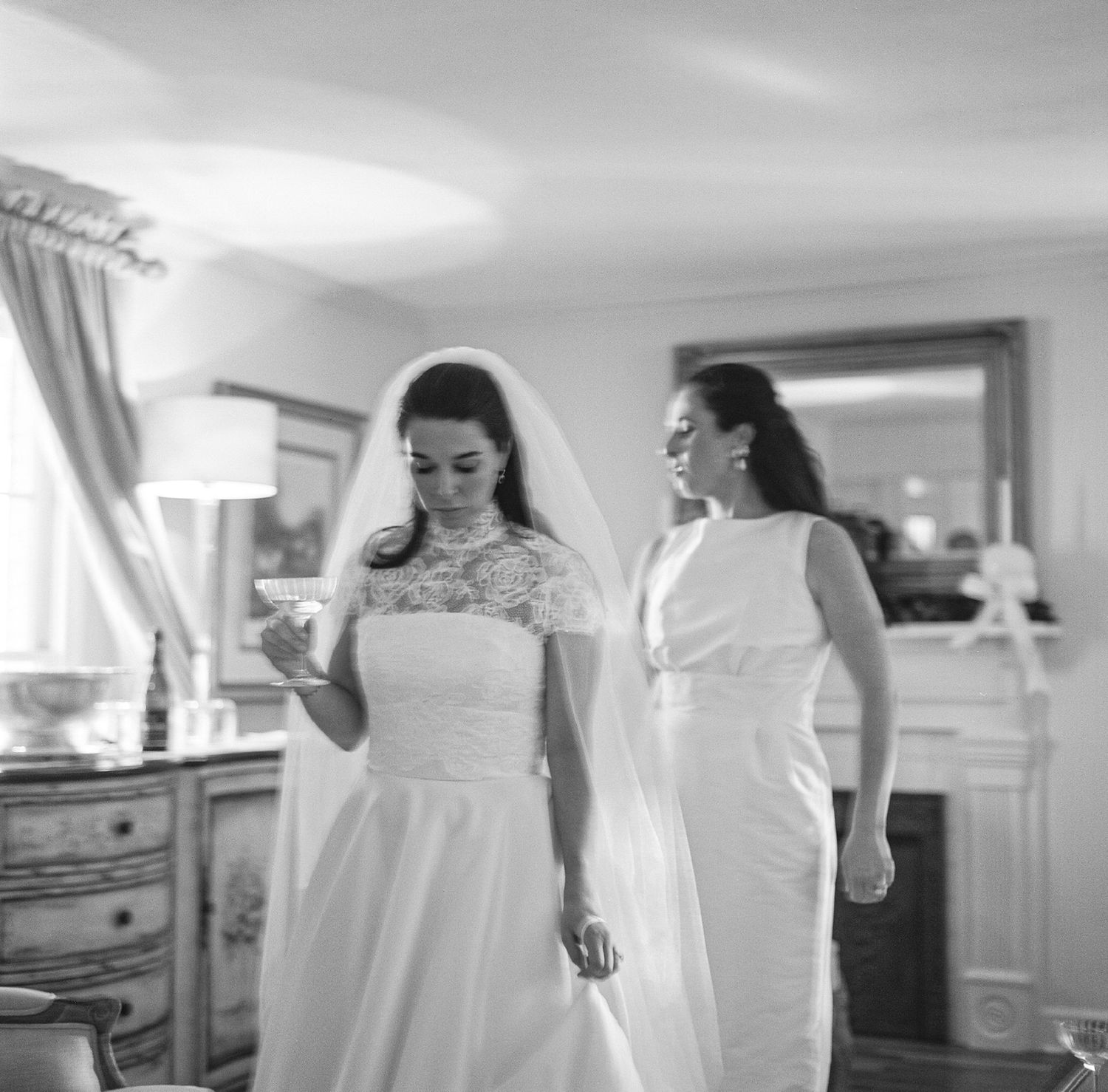 Black and white photos showing wedding preparation moments in a bright indoor space.