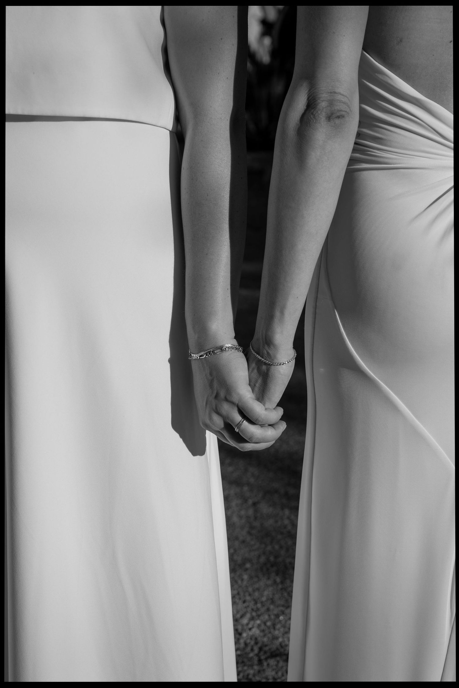 Close-up black and white detail shots of elegant white wedding dresses.