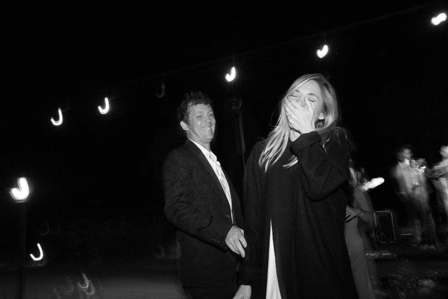 Black and white nighttime photos of guests dancing at an outdoor event.
