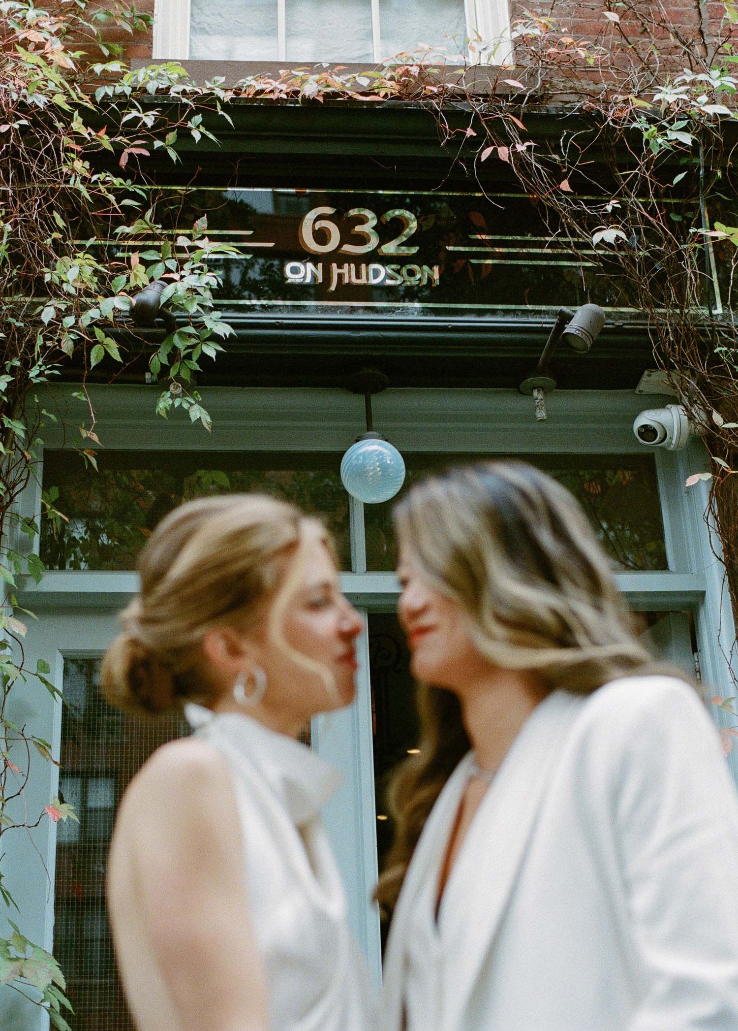 A series of intimate moments captured outside a brick building numbered 632.