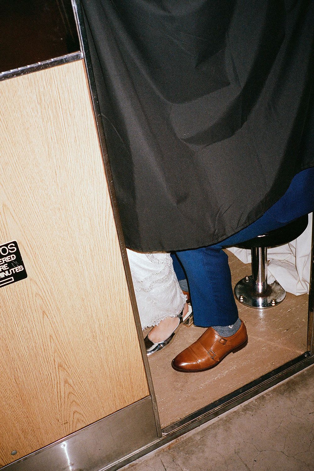Close-up of formal shoes and dress hem in photoshoot setting.