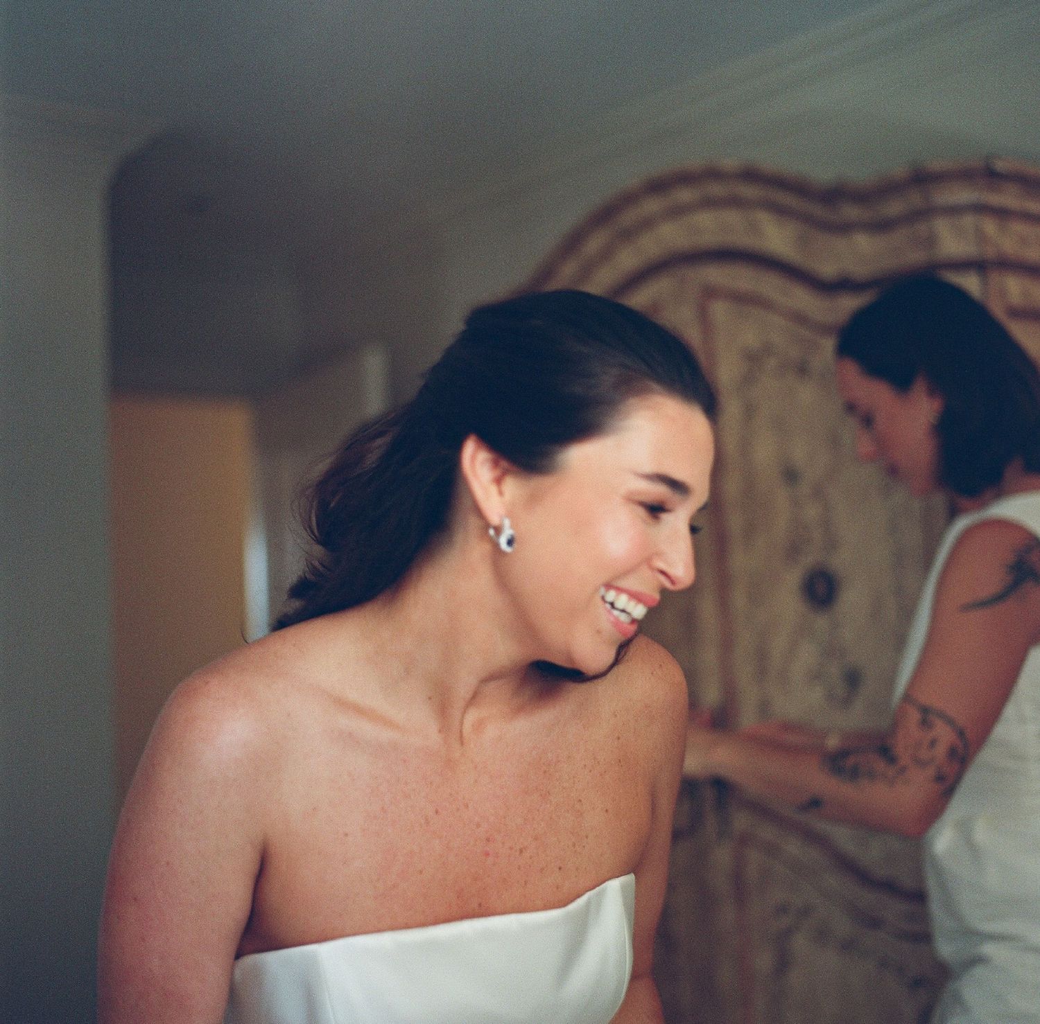 Candid moments captured during wedding preparations in an indoor setting.
