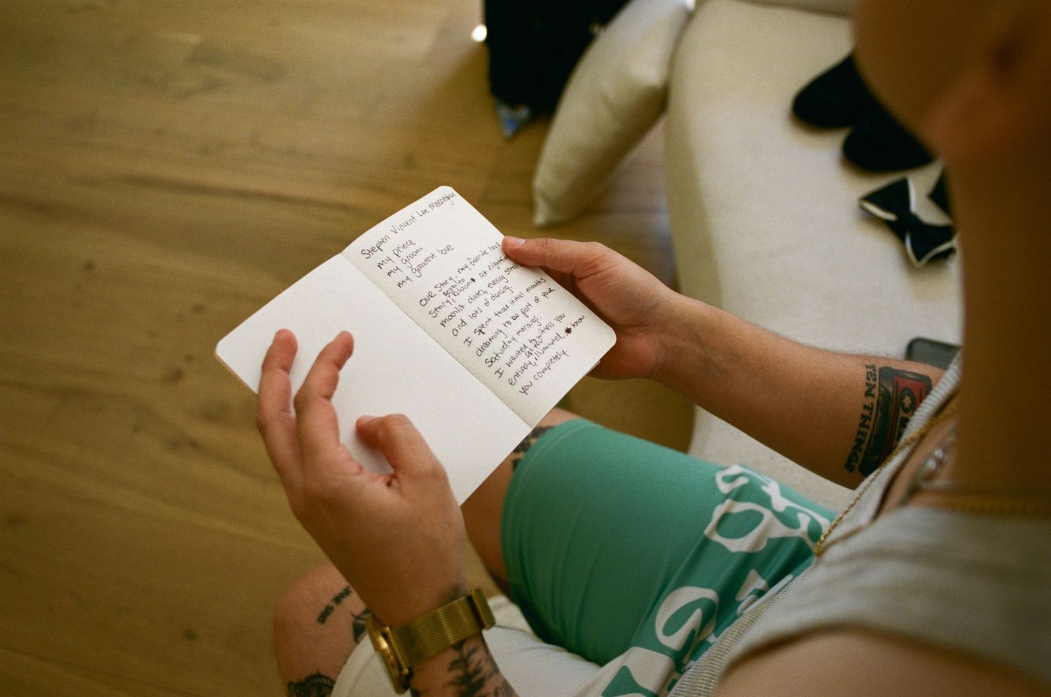 Close-up shots of hands holding and reading a green book or document.