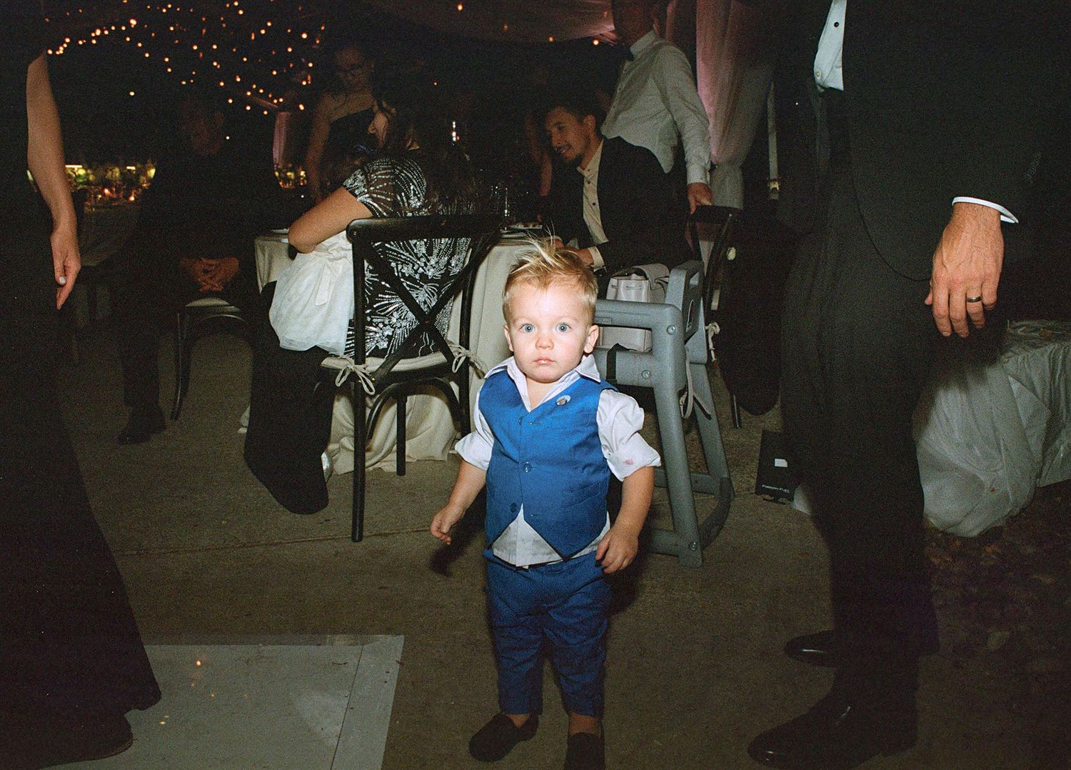 Young child dancing and having fun at a wedding reception celebration.