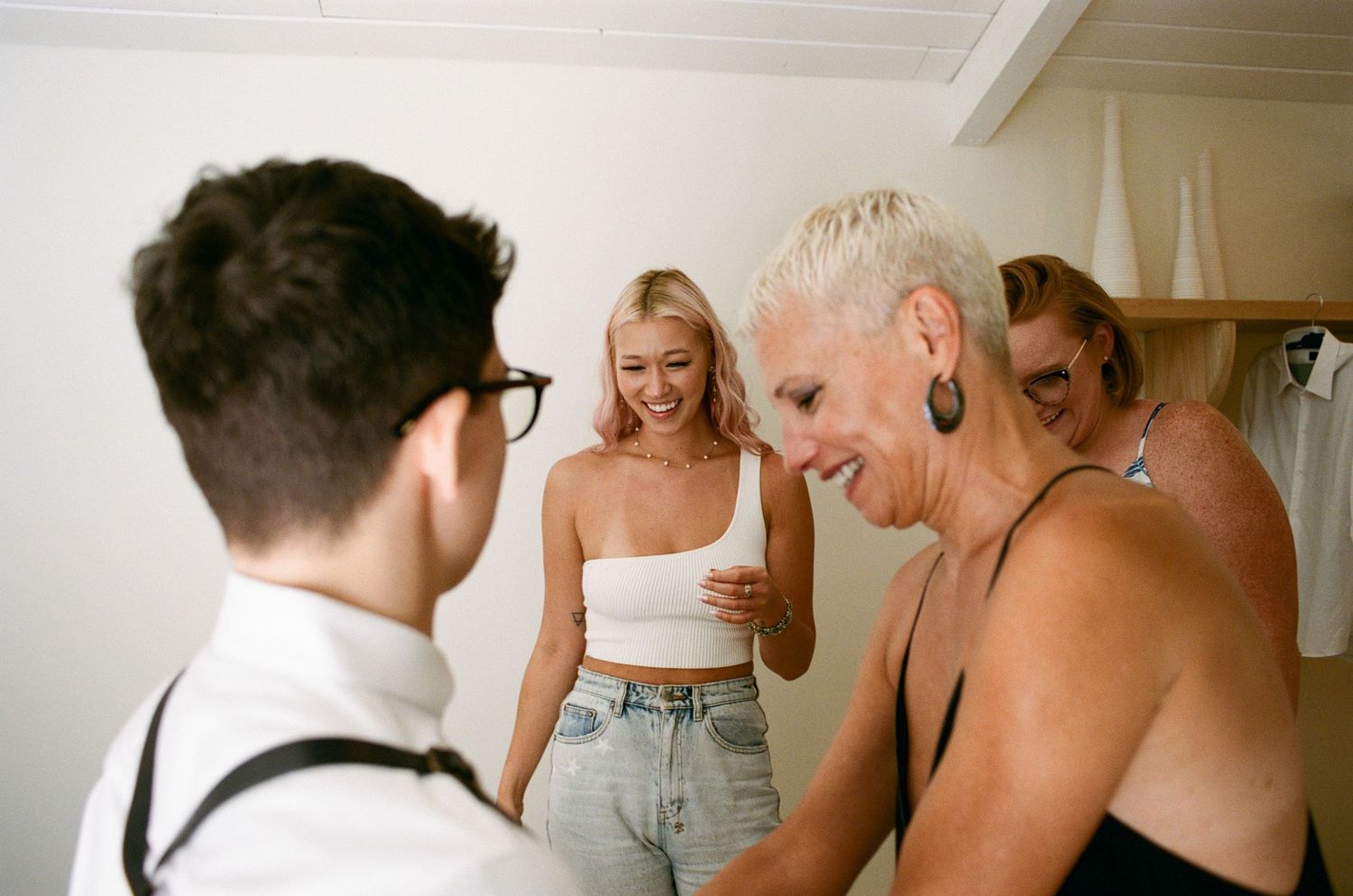 People interacting in a bright interior space with natural lighting.
