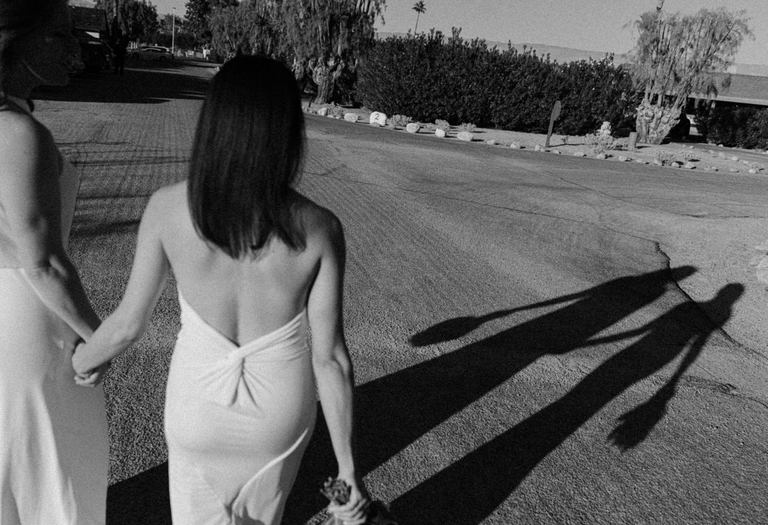 Long shadows cast on a pathway during an outdoor event.