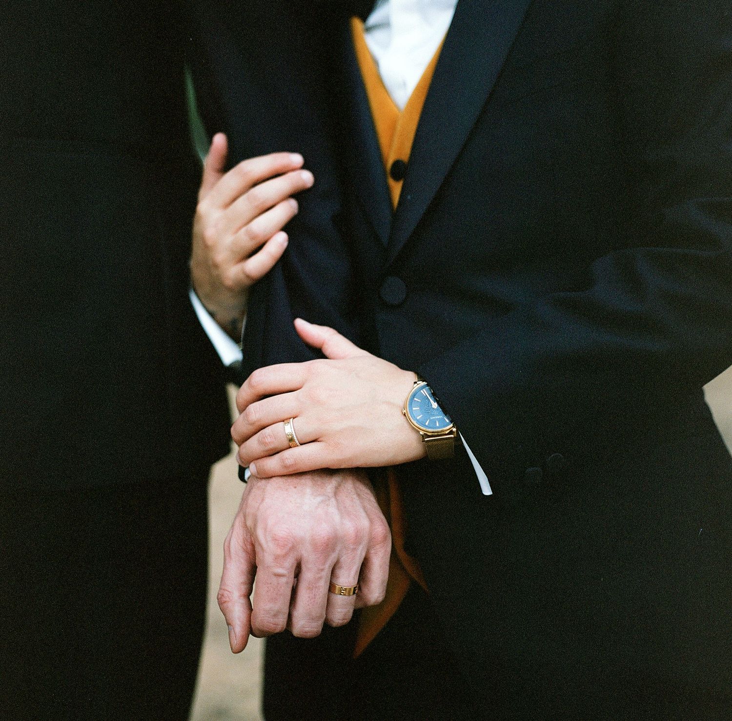 Detail shots of hands and formal wear accessories at a black tie event.